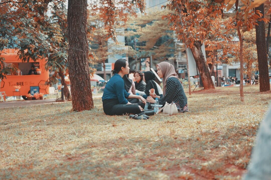 group of people discussing in park